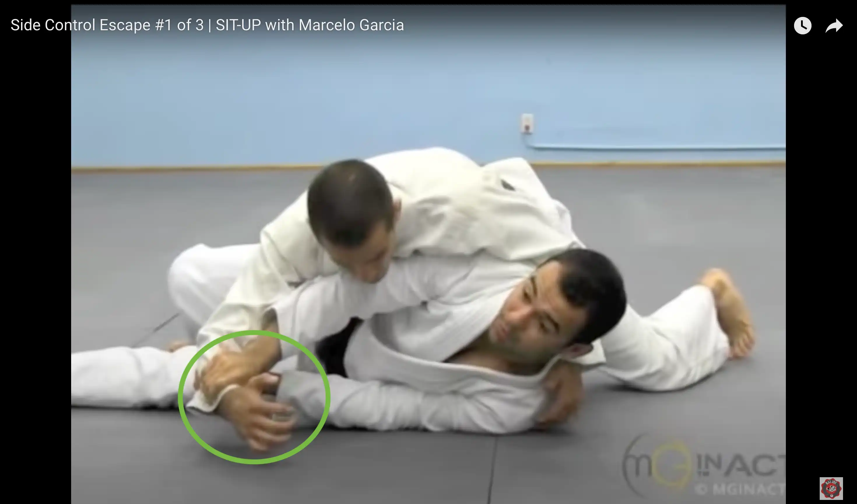 Marcelo Garcia turning away from bottom side control with grip